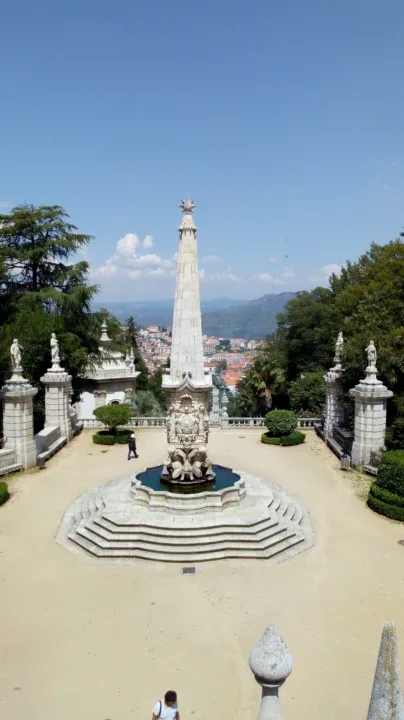 a fountain with a statue in the middle of it