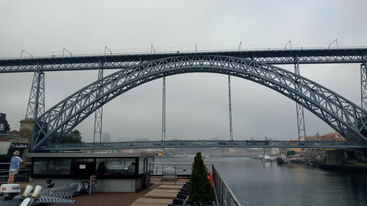 a bridge over water with boats and a boat
