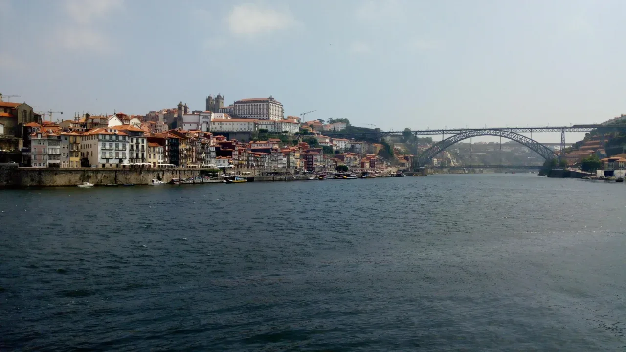 a body of water with buildings and a bridge