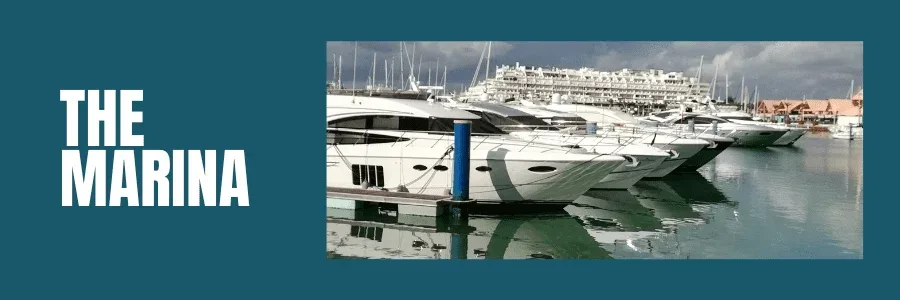 is vilamoura worth visiting post image showing row of boats in the marina and marina building in the background