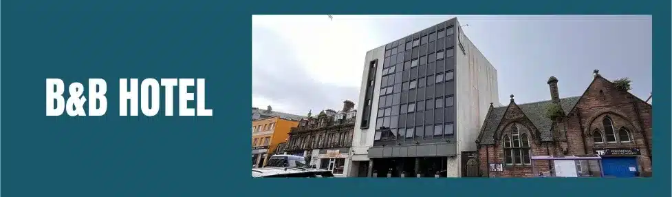 a building with windows and a car parked on the side