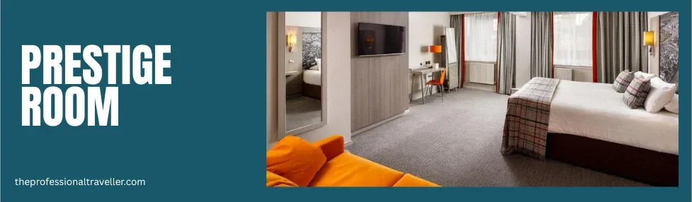 mercure inverness prestige room showing double bed, sofa, desk and tv on the wall